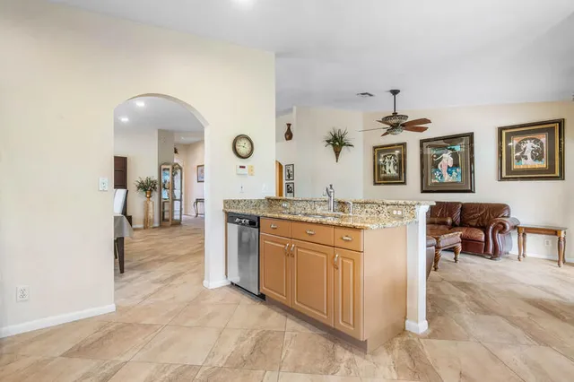a spacious bathroom with a granite countertop sink a mirror and shower
