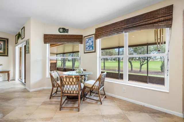 a dining room with furniture and window
