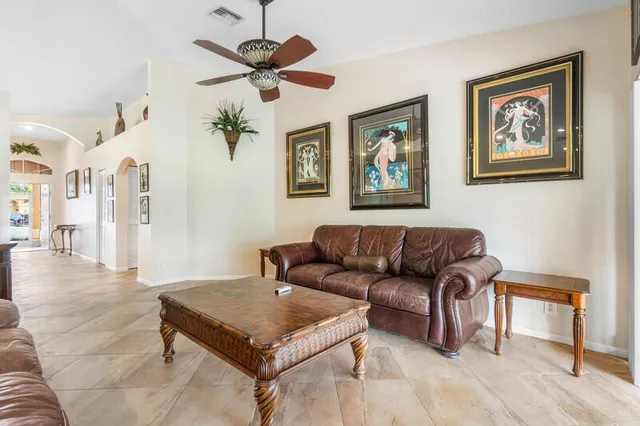 a living room with furniture a table and wooden floor