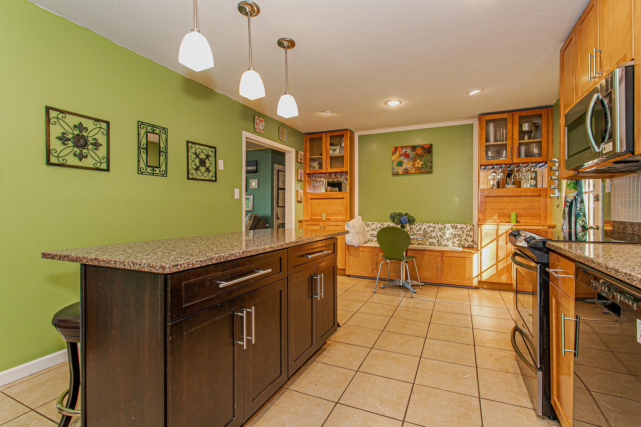 4409 Deerfield Road Knoxville, TN 37921 - Photo 12 of 40 a kitchen that has a lot of cabinets in it and wooden floors