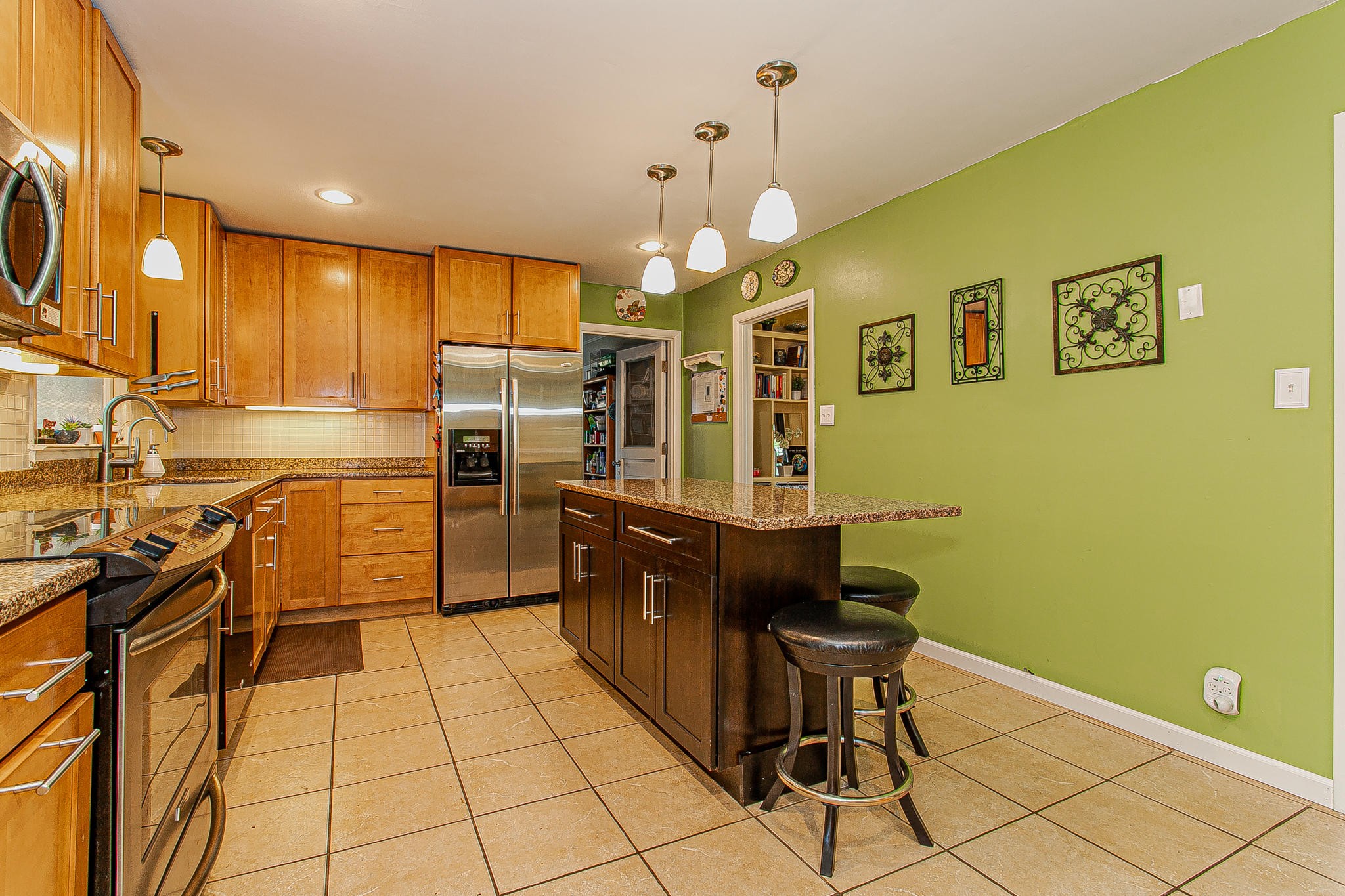 4409 Deerfield Road Knoxville, TN 37921 - Photo 13 of 40 a kitchen with stainless steel appliances granite countertop a sink and cabinets