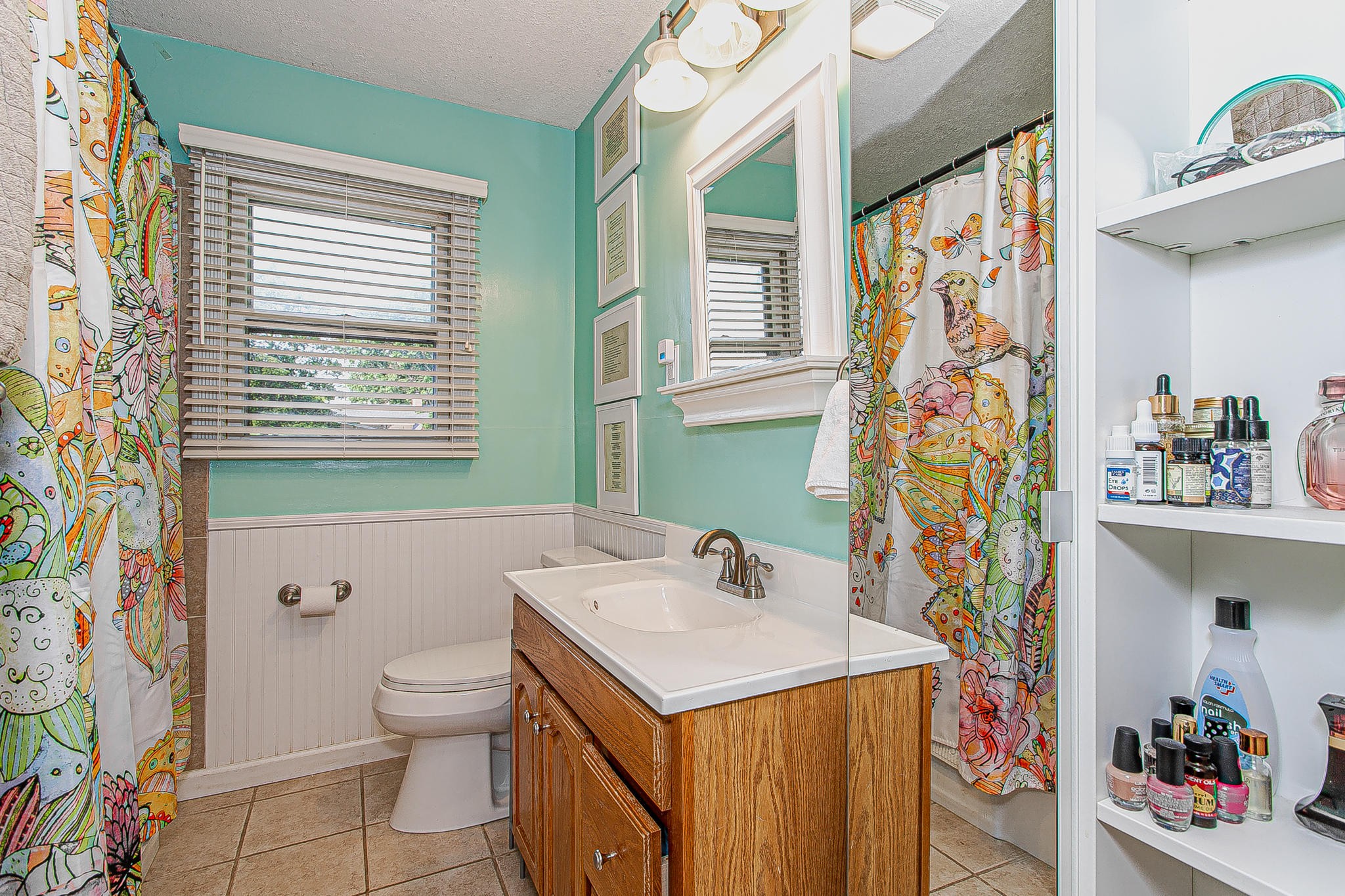 4409 Deerfield Road Knoxville, TN 37921 - Photo 30 of 40 a bathroom with a sink a toilet and a shower curtain