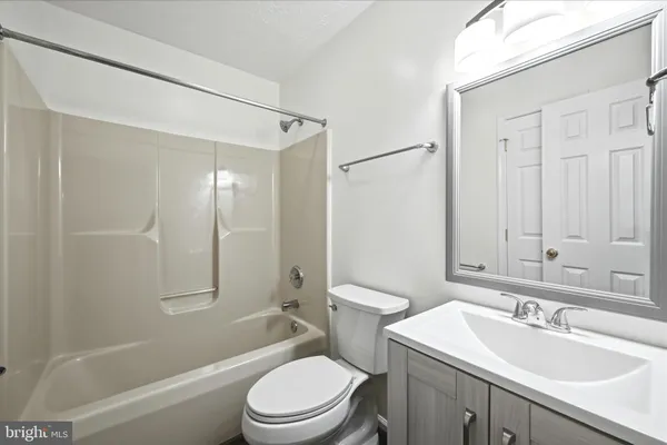 a bathroom with a sink toilet vanity and shower