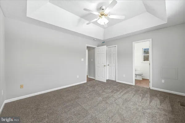 a view of an empty room with a ceiling fan