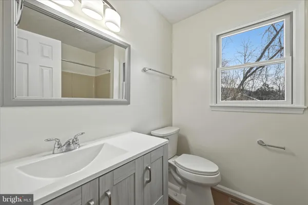 a bathroom with a sink toilet and a mirror