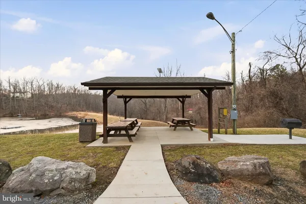 a view of a patio with a table and chairs under an umbrella