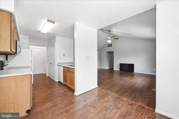 a view of a kitchen with a sink and a refrigerator