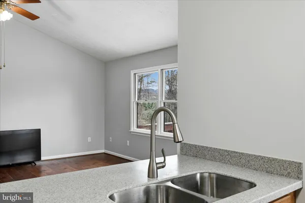 a kitchen with a sink and a window