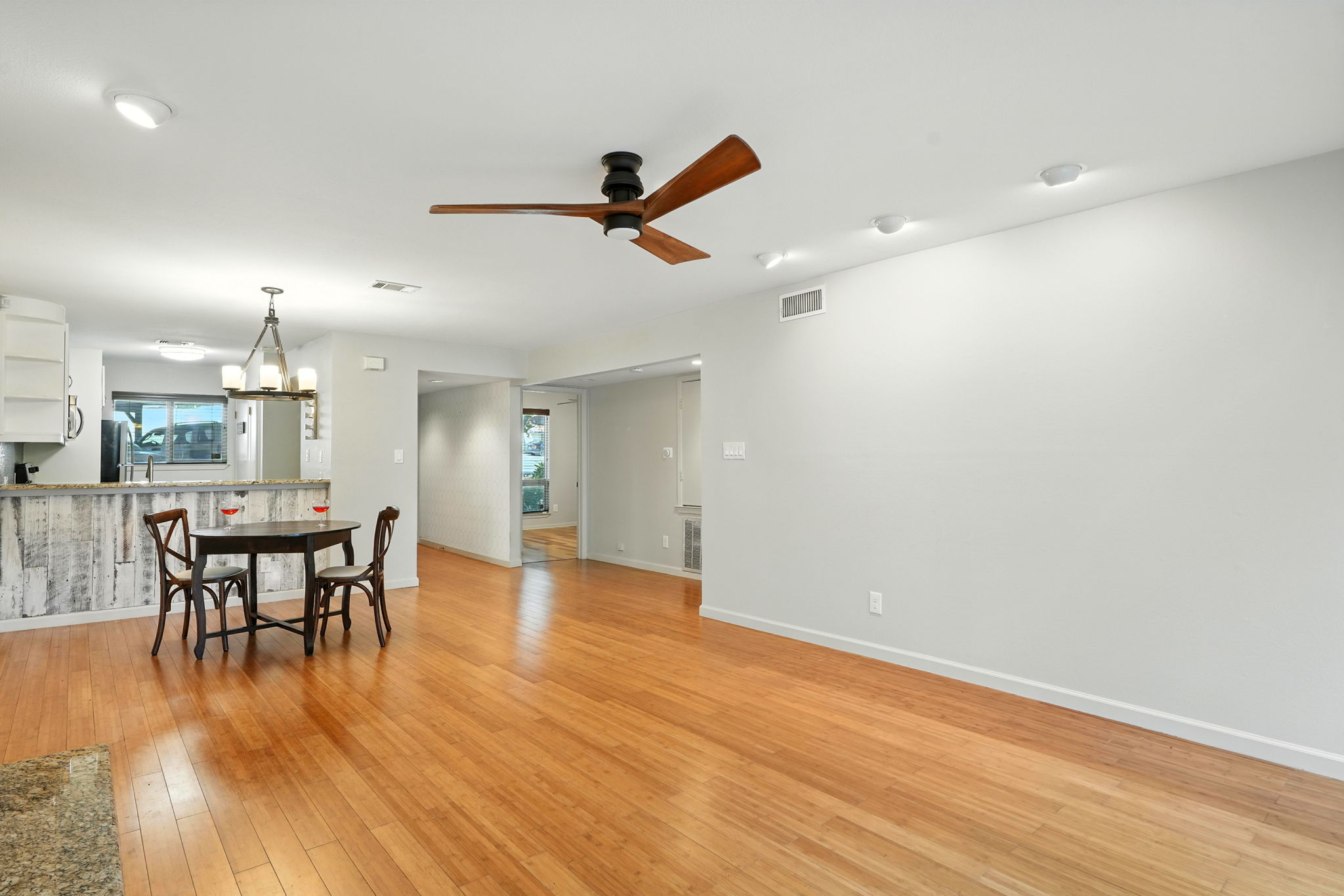2918 Ranch Road 620 North, Unit C115 Austin, TX 78734 - Photo 6 of 39 Dining room with a ceiling fan, light wood-type flooring, and a chandelier