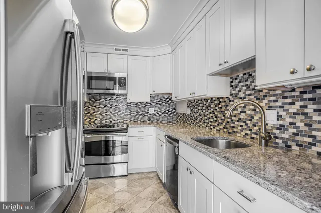 a kitchen with a sink a stove and refrigerator