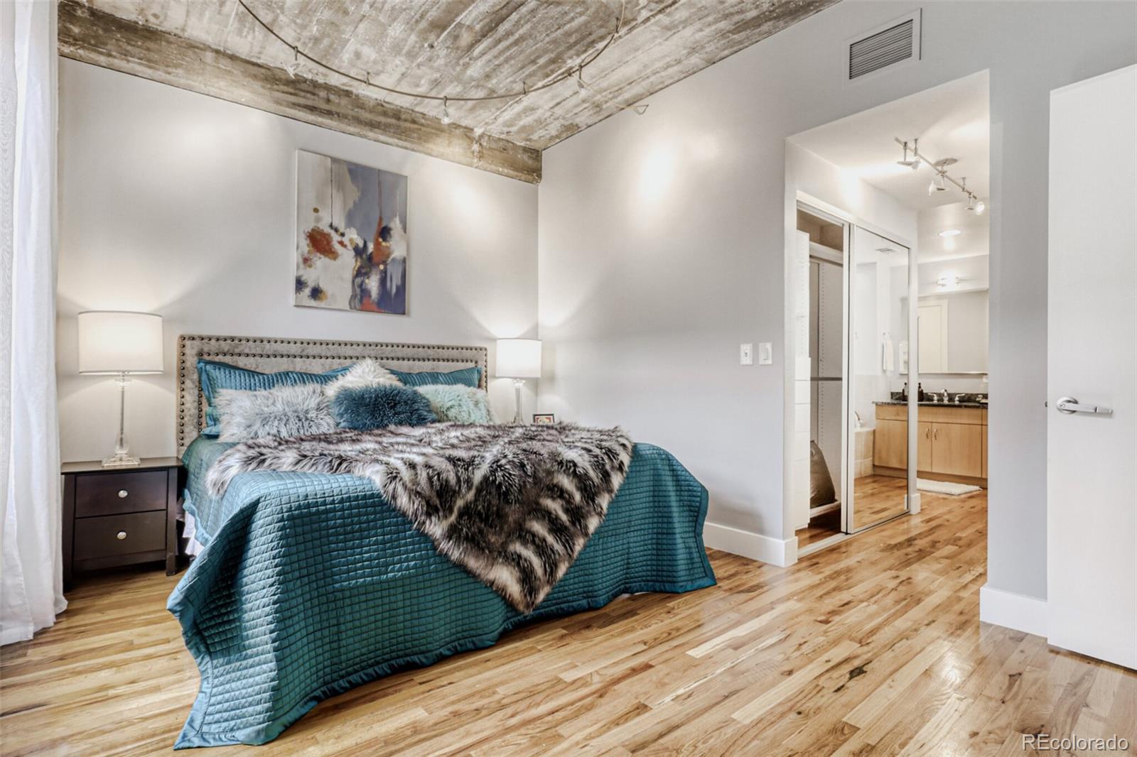 1449 Wynkoop Street, Unit 506 Denver, CO 80202 - Photo 13 of 39 a bedroom with a bed and a painting on the wall