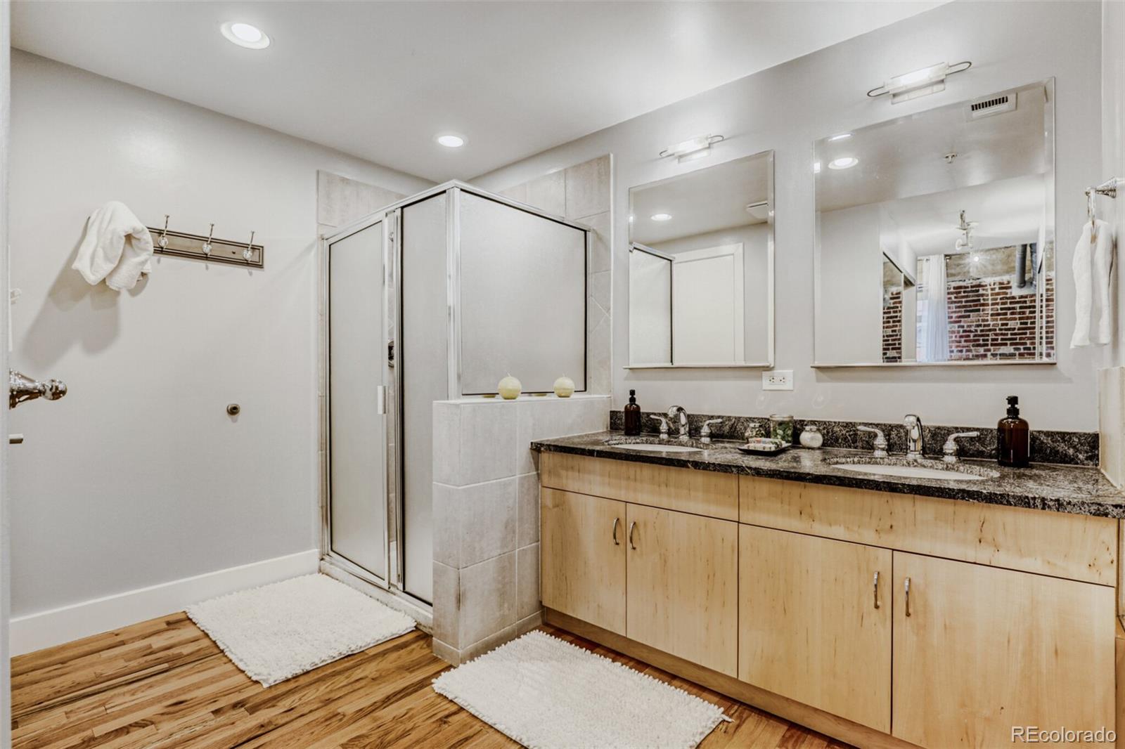 1449 Wynkoop Street, Unit 506 Denver, CO 80202 - Photo 17 of 39 a bathroom with a sink a mirror and a shower