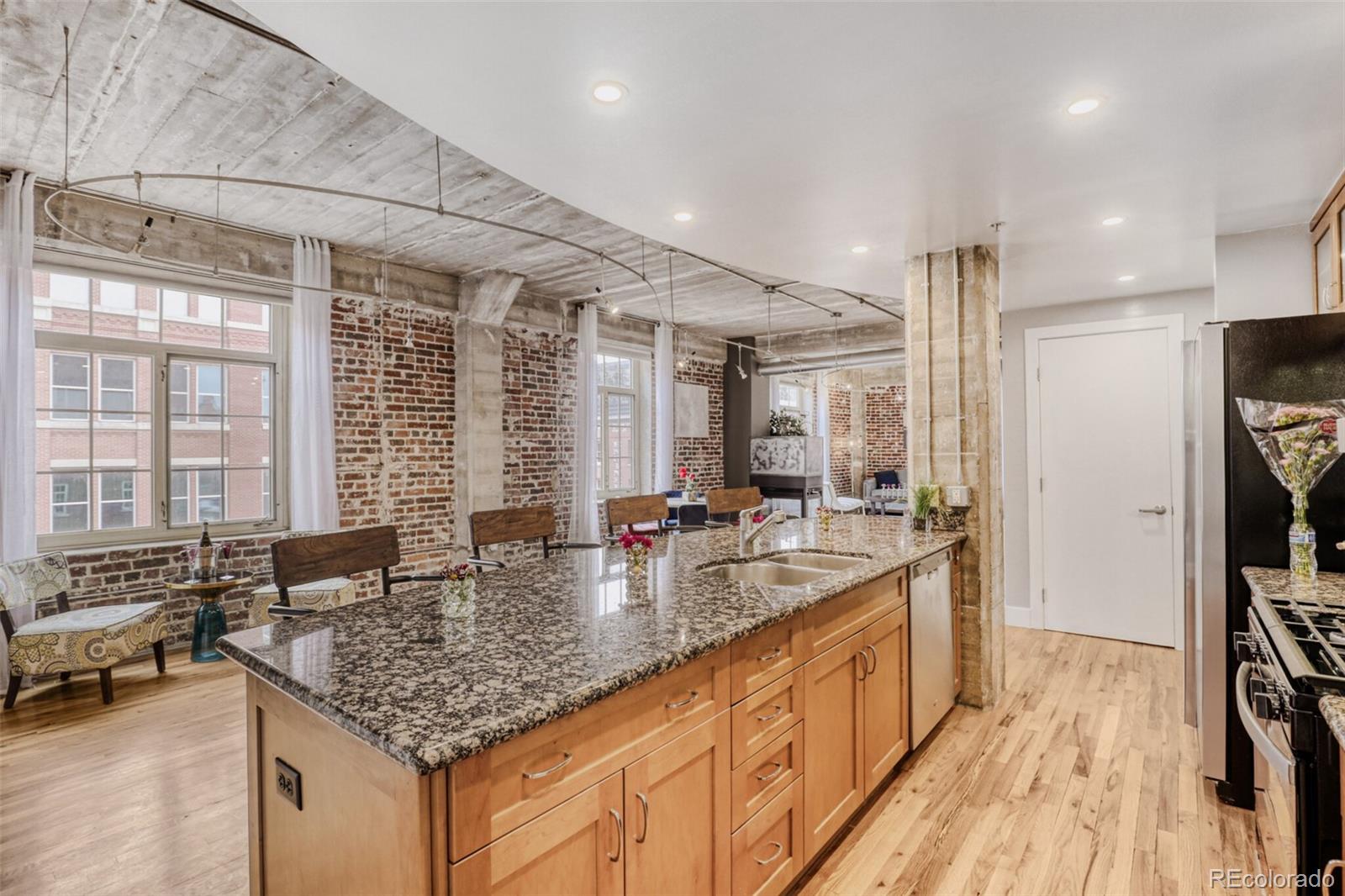 1449 Wynkoop Street, Unit 506 Denver, CO 80202 - Photo 2 of 39 a kitchen with sink stove and refrigerator