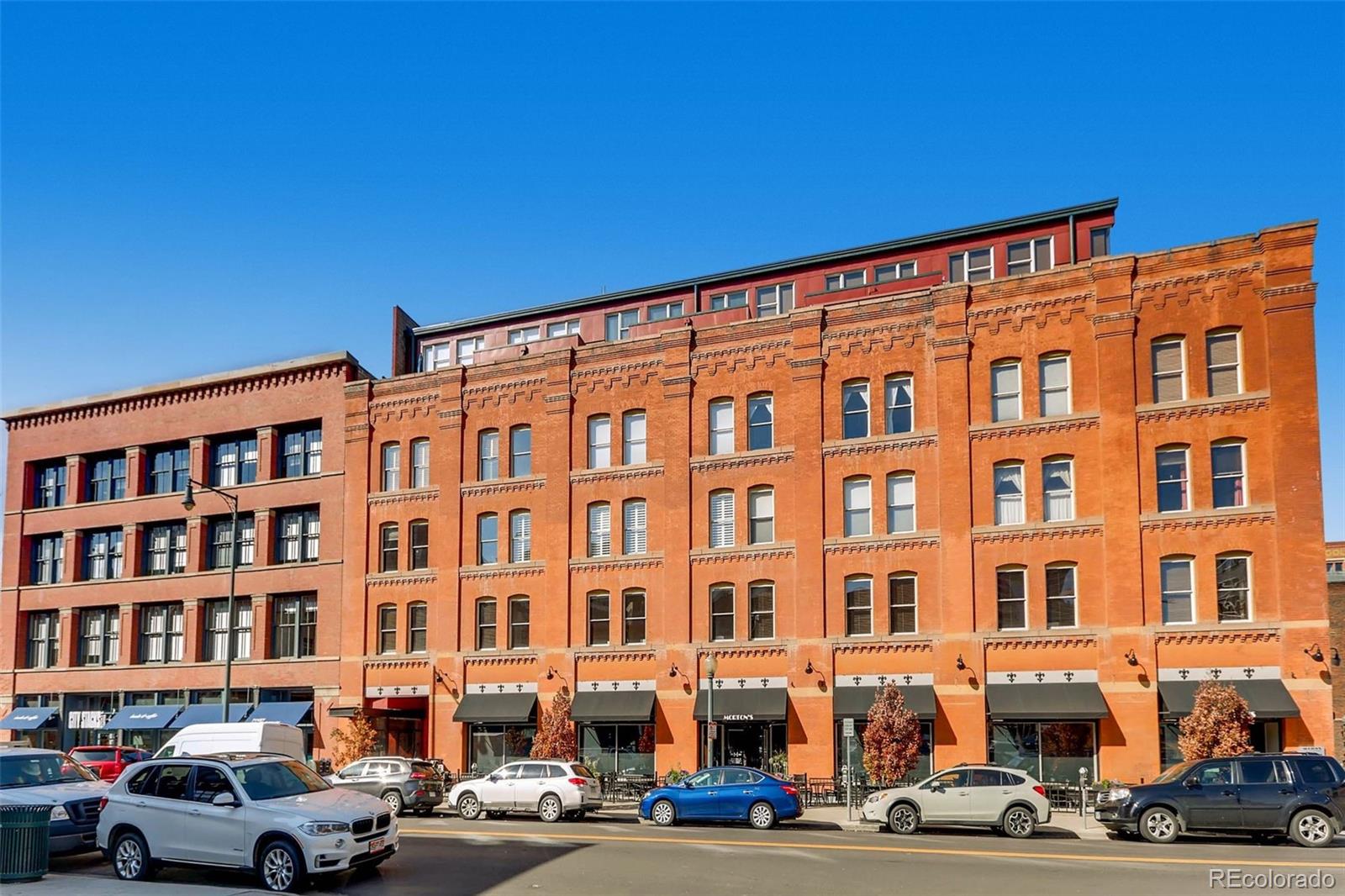 1449 Wynkoop Street, Unit 506 Denver, CO 80202 - Photo 30 of 39 a front view of a building with lot of cars and trees