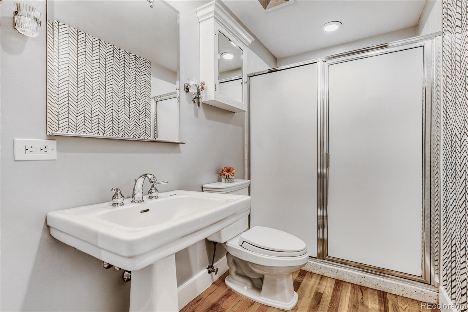 1449 Wynkoop Street, Unit 506 Denver, CO 80202 - Photo 6 of 39 a bathroom with a sink a toilet and shower