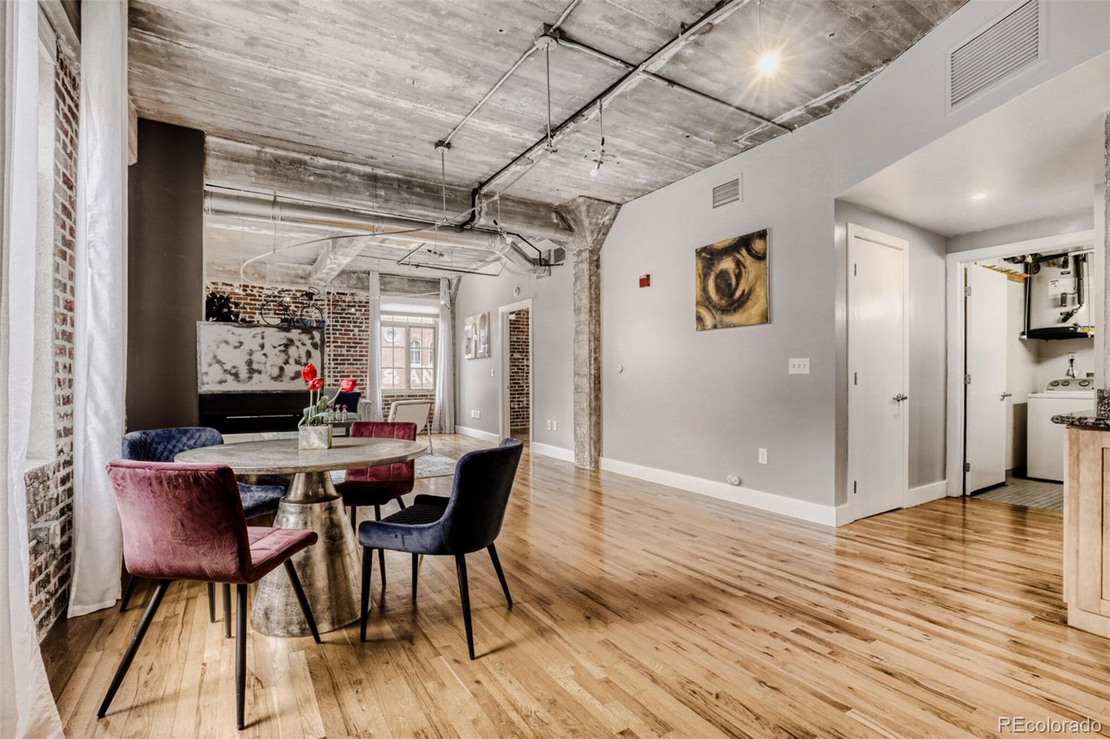 1449 Wynkoop Street, Unit 506 Denver, CO 80202 - Photo 7 of 39 a view of a dining room with furniture window and wooden floor