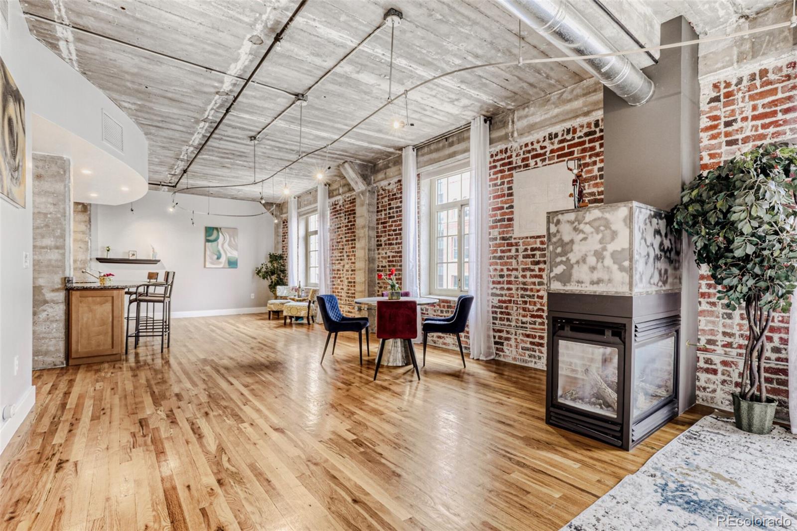 1449 Wynkoop Street, Unit 506 Denver, CO 80202 - Photo 8 of 39 a living room with furniture and a fireplace