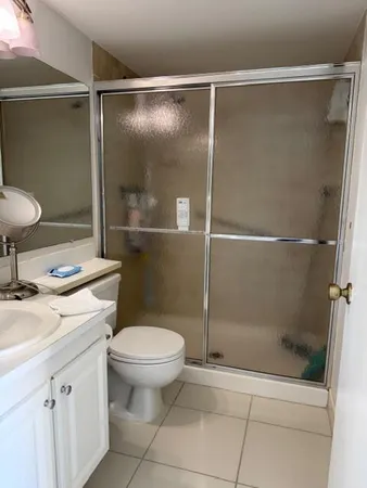 a bathroom with a shower a toilet and a sink