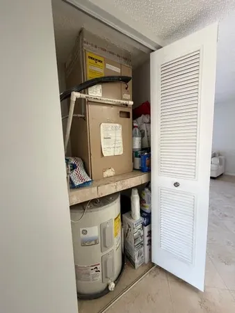 a utility room with a sink and cabinets