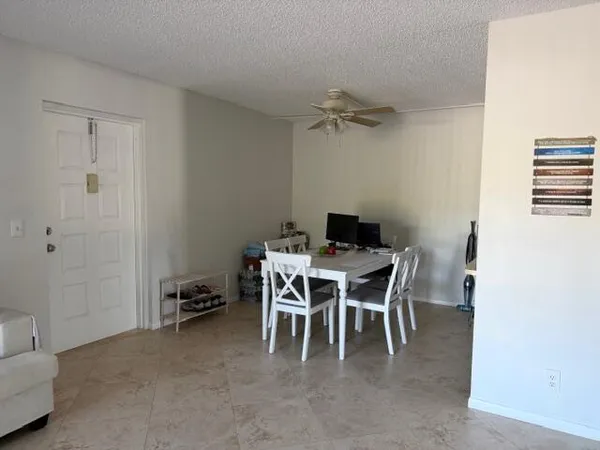 a dining room with a table and chairs