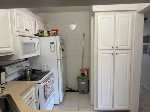 a kitchen with refrigerator and cabinets