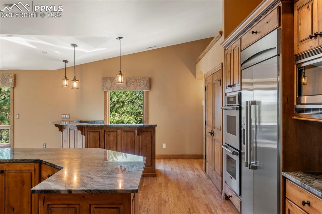 40 Upland Road Colorado Springs, CO 80906 - Photo 15 of 46 a kitchen with stainless steel appliances granite countertop a refrigerator a sink and a stove