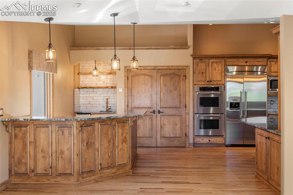 40 Upland Road Colorado Springs, CO 80906 - Photo 16 of 46 an empty room with wooden floor and windows