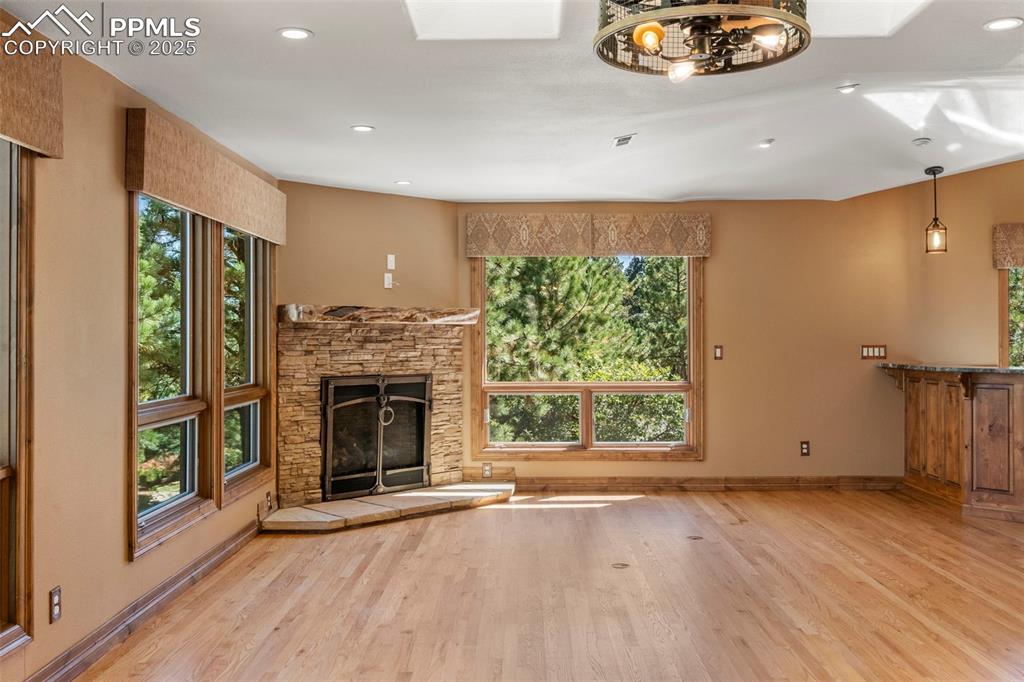 40 Upland Road Colorado Springs, CO 80906 - Photo 19 of 46 an empty room with windows fireplace and wooden floor