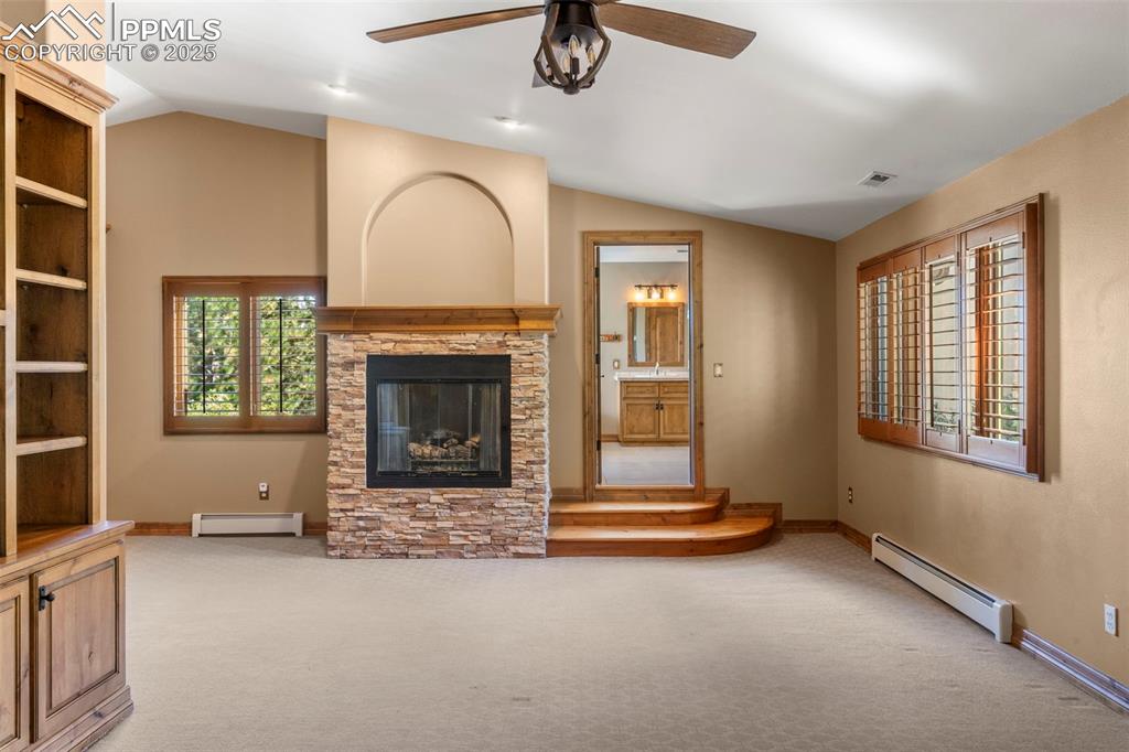 40 Upland Road Colorado Springs, CO 80906 - Photo 21 of 46 an empty room with fireplace and windows