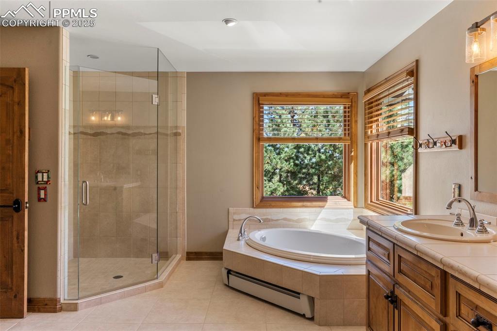 40 Upland Road Colorado Springs, CO 80906 - Photo 23 of 46 a spacious bathroom with a granite countertop tub sink and shower