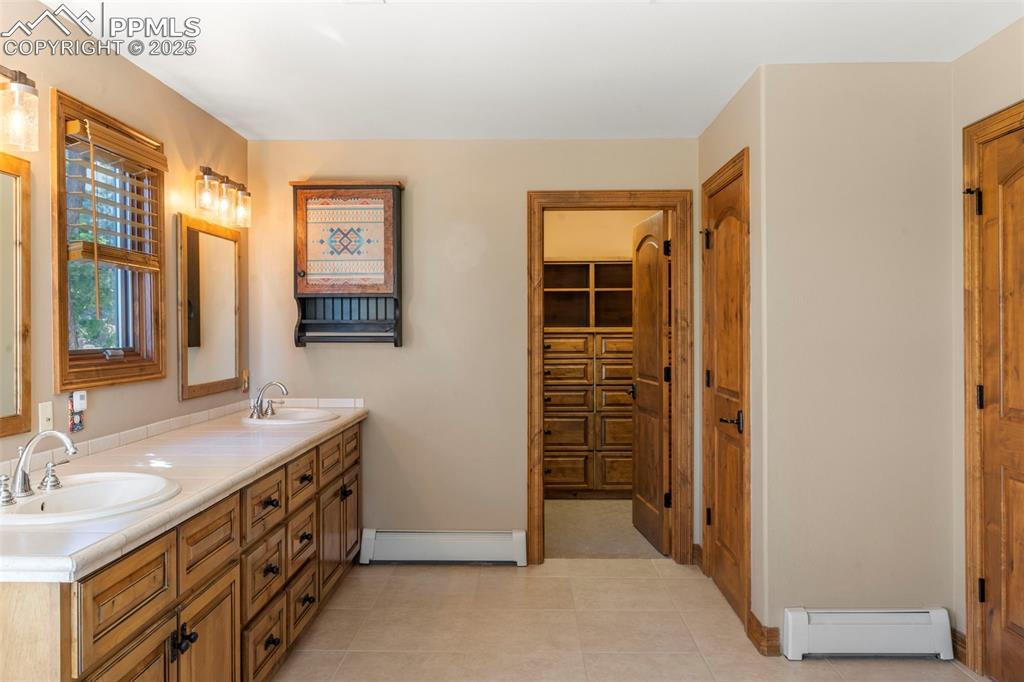 40 Upland Road Colorado Springs, CO 80906 - Photo 24 of 46 a bathroom with a sink a mirror and a shower