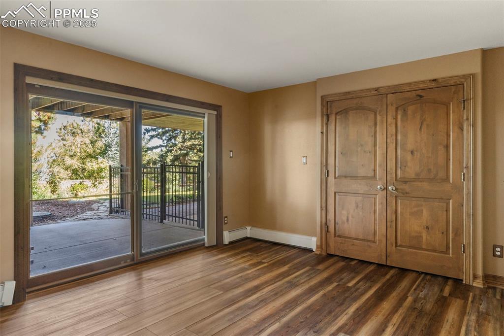 40 Upland Road Colorado Springs, CO 80906 - Photo 28 of 46 a view of an empty room with wooden floor and a window