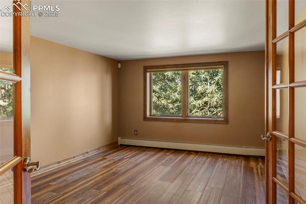 40 Upland Road Colorado Springs, CO 80906 - Photo 30 of 46 a view of an empty room with wooden floor and a window