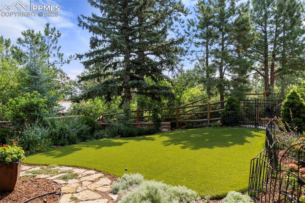 40 Upland Road Colorado Springs, CO 80906 - Photo 36 of 46 a view of a swimming pool with lawn chairs and plants
