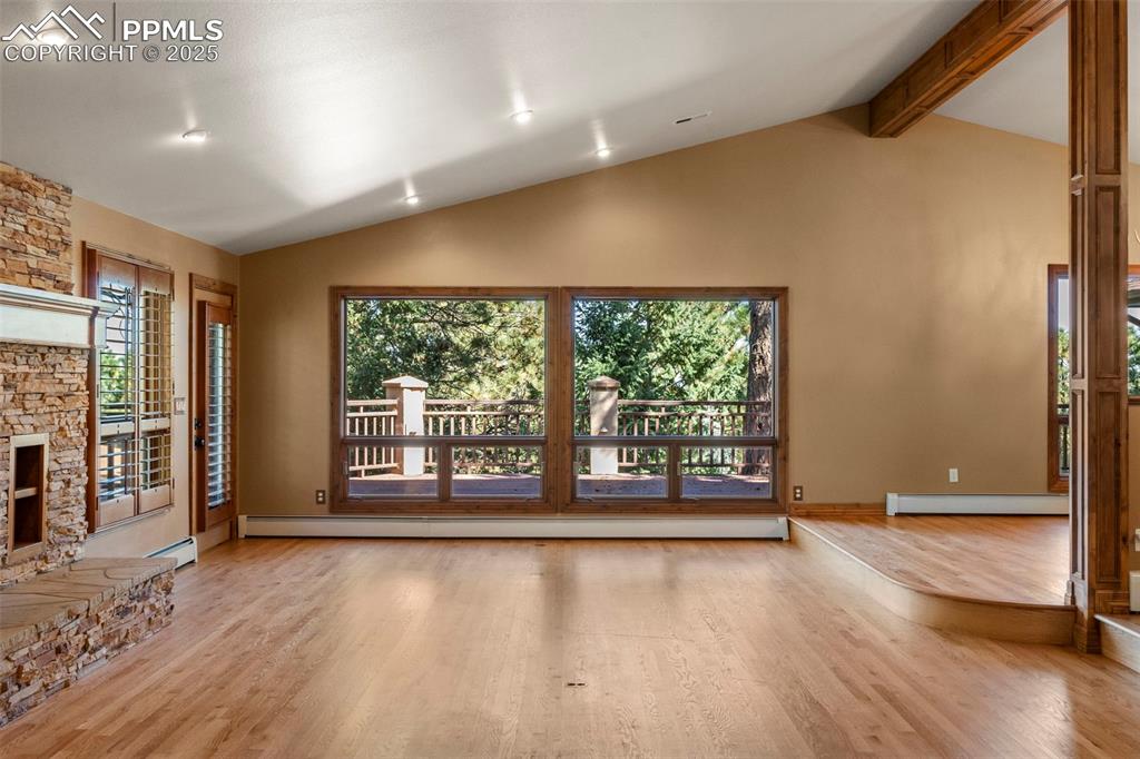 40 Upland Road Colorado Springs, CO 80906 - Photo 5 of 46 a view of an empty room with a window and wooden floor