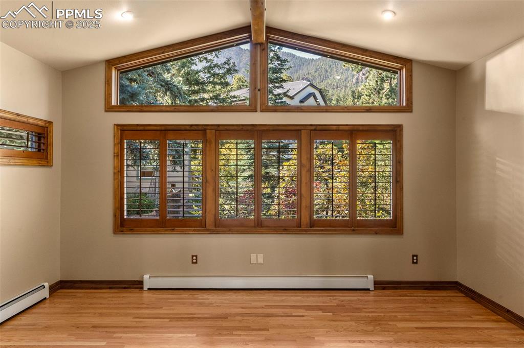 40 Upland Road Colorado Springs, CO 80906 - Photo 9 of 46 an empty room with wooden floor and windows