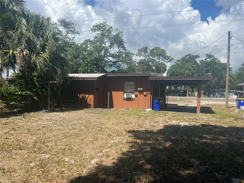 989 South Fiske Boulevard Rockledge, FL 32955 - Photo 14 of 14 a tall tree in front of a house with a yard