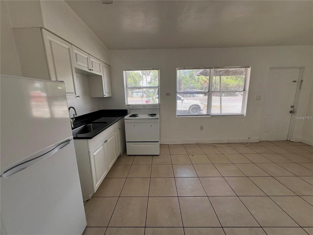 989 South Fiske Boulevard Rockledge, FL 32955 - Photo 5 of 14 a kitchen with a sink a stove cabinets and a window