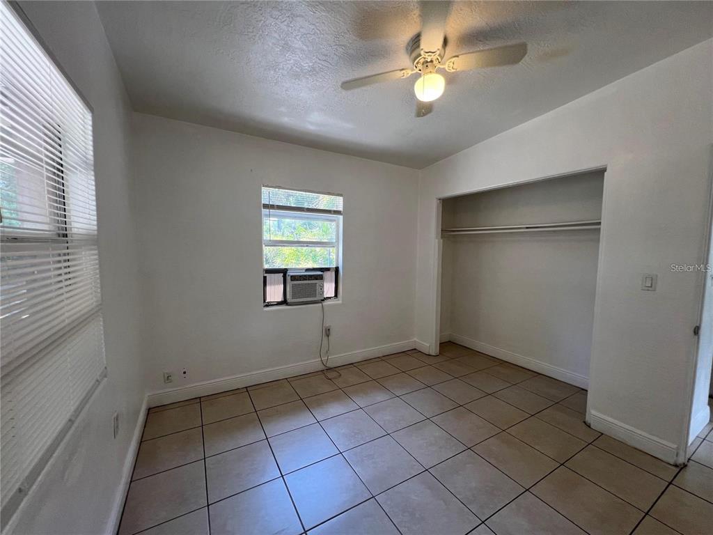 989 South Fiske Boulevard Rockledge, FL 32955 - Photo 6 of 14 an empty room with windows and fan