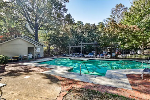 a view of a house with backyard and a tree