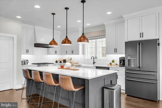 a large kitchen with lots of counter space and windows