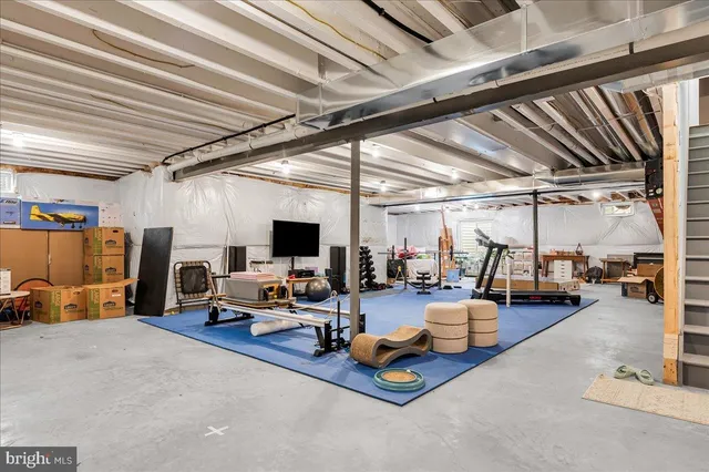 a view of a workspace with furniture and a flat screen tv