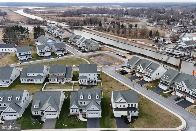 a kitchen with a sink and a stove with wooden floor