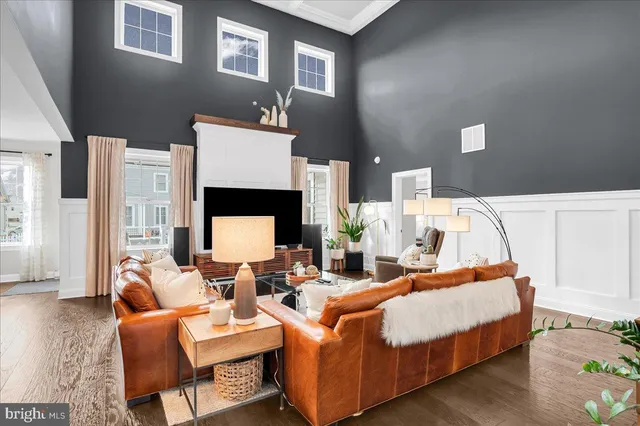 a living room with fireplace furniture and a large window