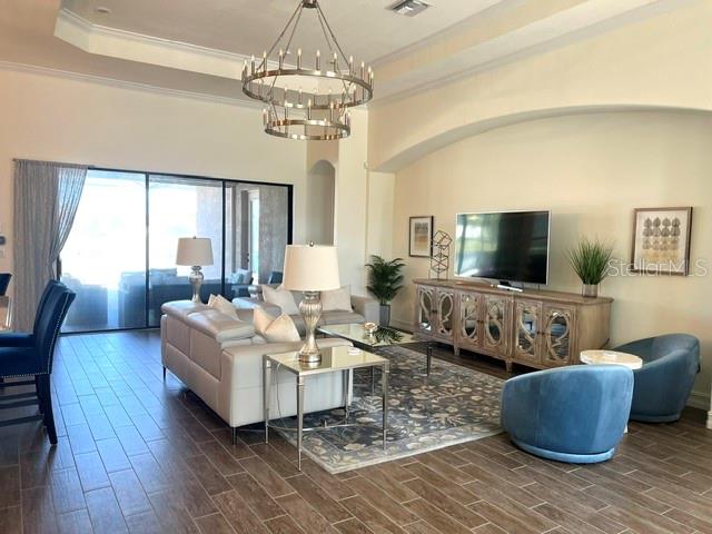5528 Arnie Loop Lakewood Ranch, FL 34211 - Photo 6 of 59 a living room with furniture and a flat screen tv