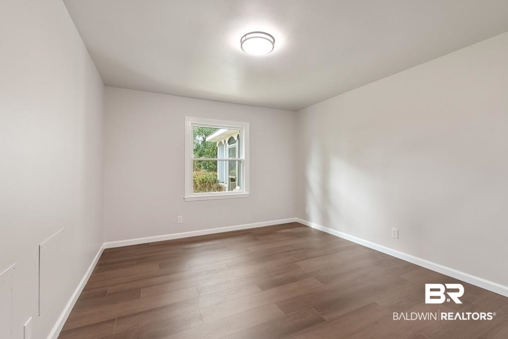 554 Stuart Street Daphne, AL 36526 - Photo 21 of 49 Spare room with dark wood-type flooring