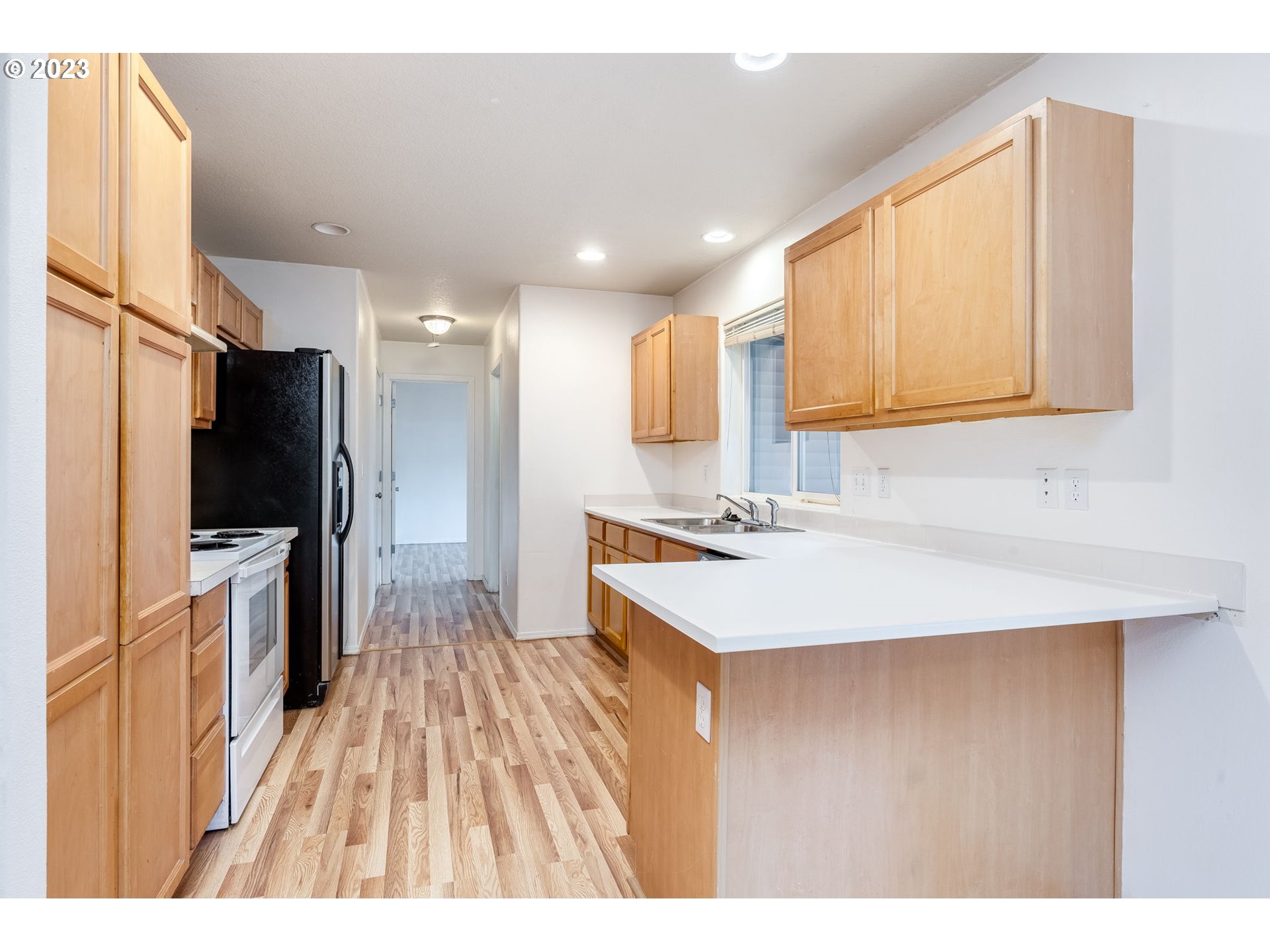 713 Northeast Mariners Loop Portland, OR 97211 - Photo 15 of 40 a kitchen with a sink a counter top space stainless steel appliances cabinets and a counter top space