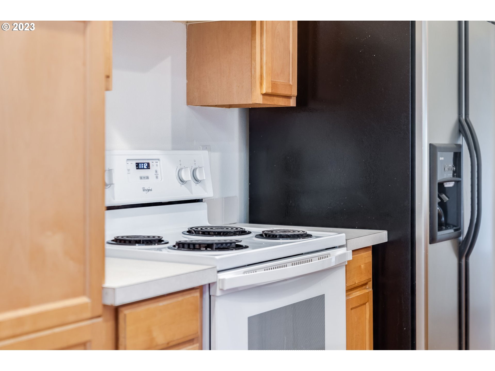 713 Northeast Mariners Loop Portland, OR 97211 - Photo 16 of 40 a kitchen with stainless steel appliances granite countertop a stove and a refrigerator