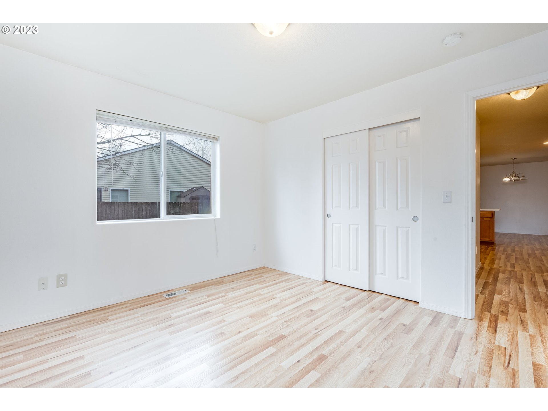 713 Northeast Mariners Loop Portland, OR 97211 - Photo 18 of 40 a view of an empty room with wooden floor and a window