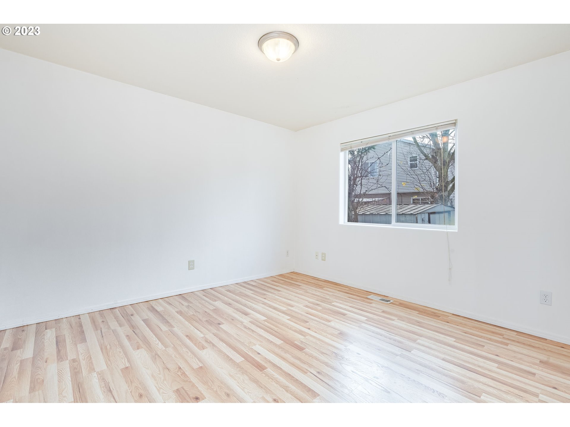 713 Northeast Mariners Loop Portland, OR 97211 - Photo 19 of 40 an empty room with wooden floor and windows